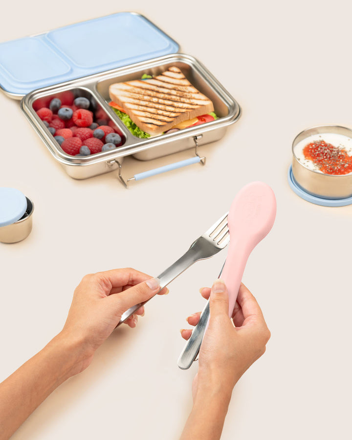 Mom packing stainless steel reusable cutlery into pink silicone case with eco-friendly lunchbox by Baboons India.