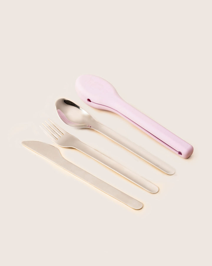 Flat lay of stainless steel spoon, fork, and knife with lilac silicone cutlery case reusable eco-friendly set India Baboons.