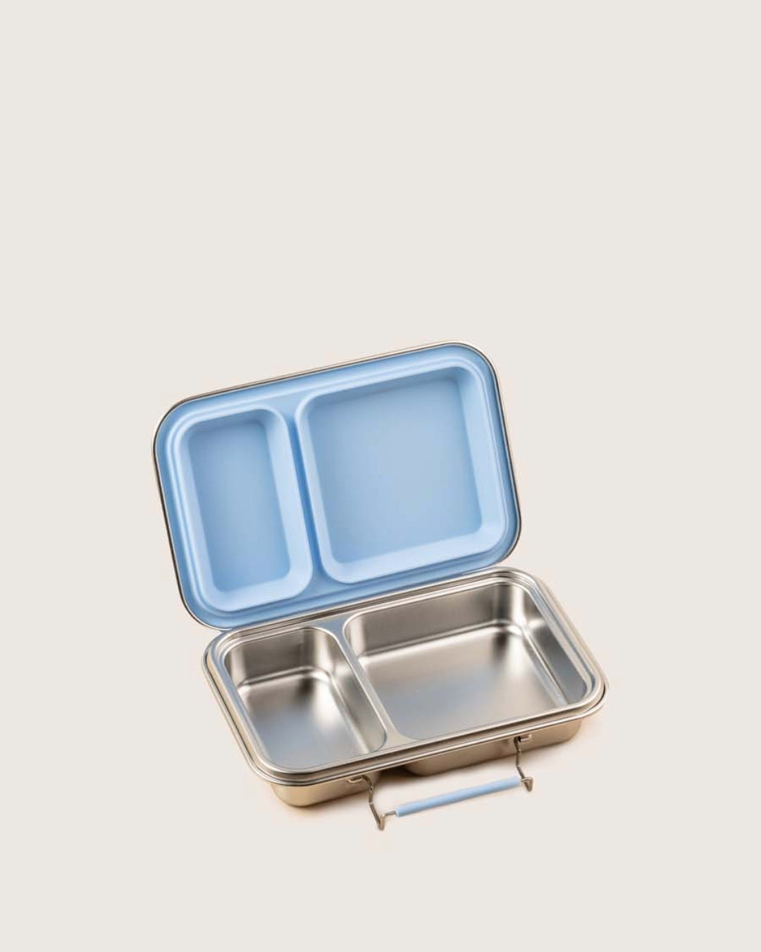 Steel lunch box with a blue lid and two compartments with removable seal on a light gray background