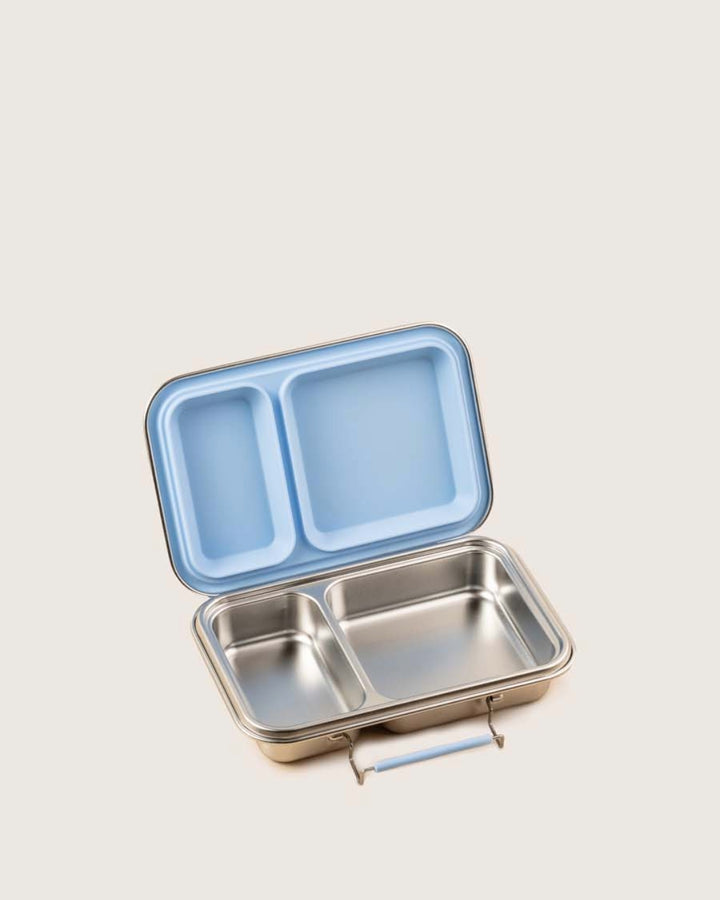 Steel lunch box with a blue lid and two compartments with removable seal on a light gray background