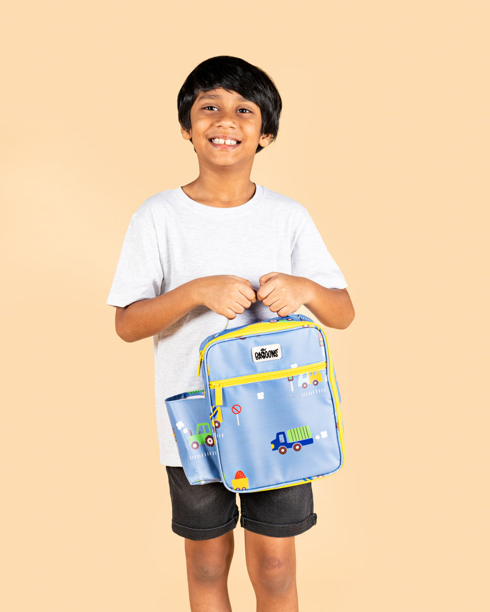 Smiling boy holding Baboons insulated kids lunch bag - blue, durable, water-resistant, perfect for bento boxes and snacks, available in India