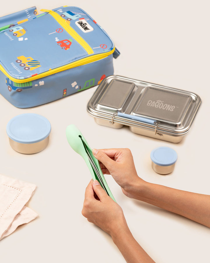 Mom packing reusable stainless steel cutlery set into mint silicone pouch with steel tiffin box cute lunchbag India Baboons.