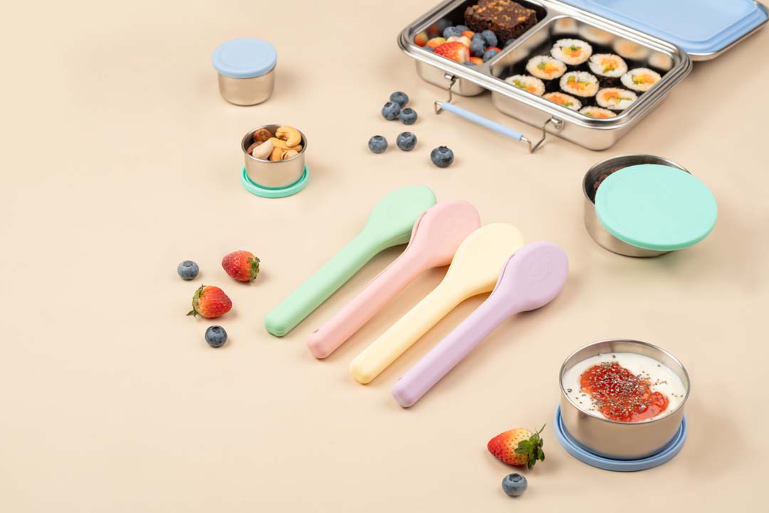 Reusable stainless steel cutlery set with pastel silicone carry cases, eco-friendly lunch cutlery India by Baboons.