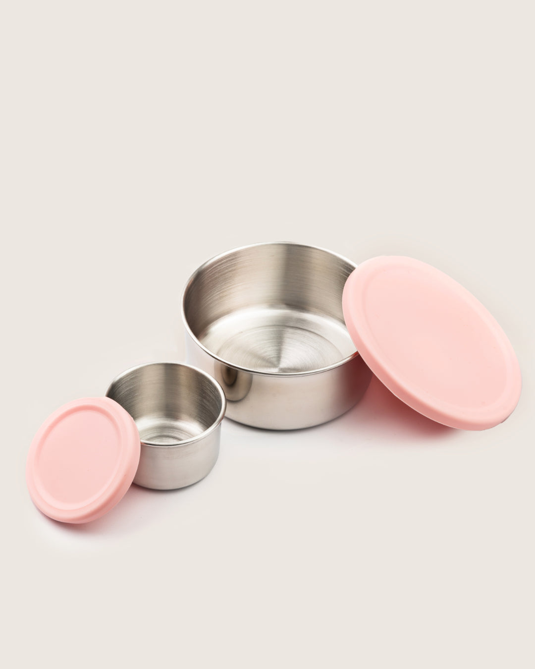 Large and small stainless steel snack containers with pink silicone lids, ideal for bento lunch boxes in India